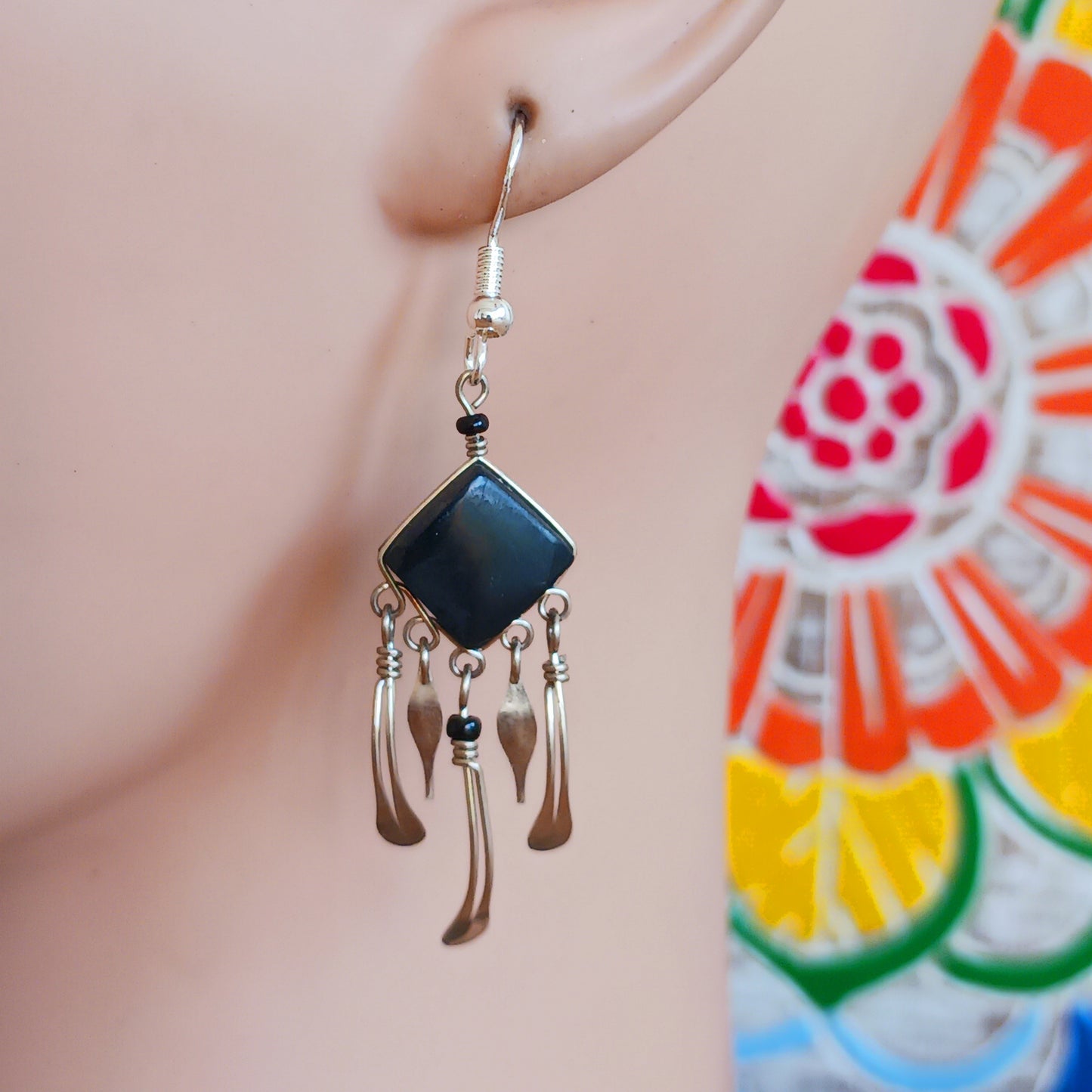 Add a touch of bohemian beauty to your look with these handmade Peruvian stone earrings. Featuring black stones and finished with silver-plated hooks, each pair is carefully crafted in small workshops in Peru.