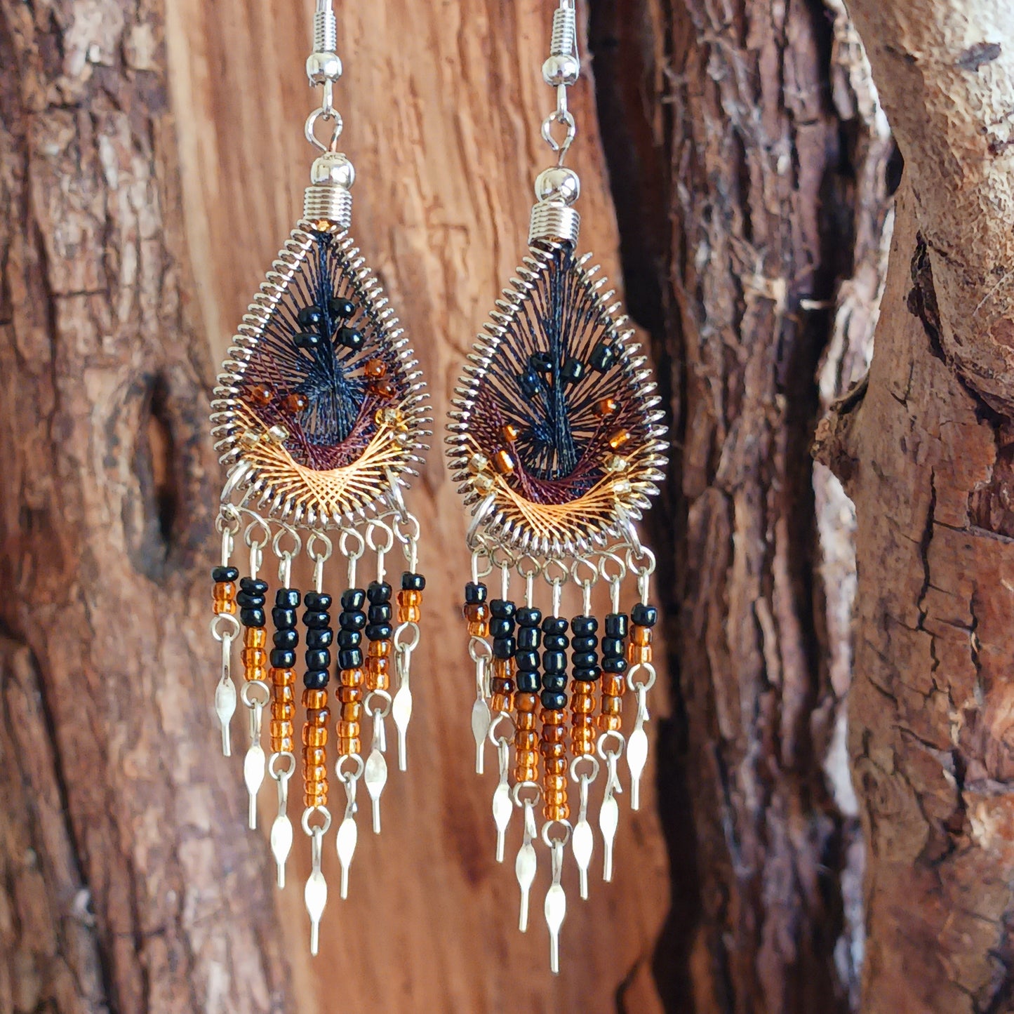 Add a splash of colour to your look with these beautiful handmade Peruvian woven teardrop earrings. Inspired by the vibrant colours and patterns of a peacock feather, each earring features intricate woven detailing complemented by coordinating beads and delicate silver-tone embellishments.