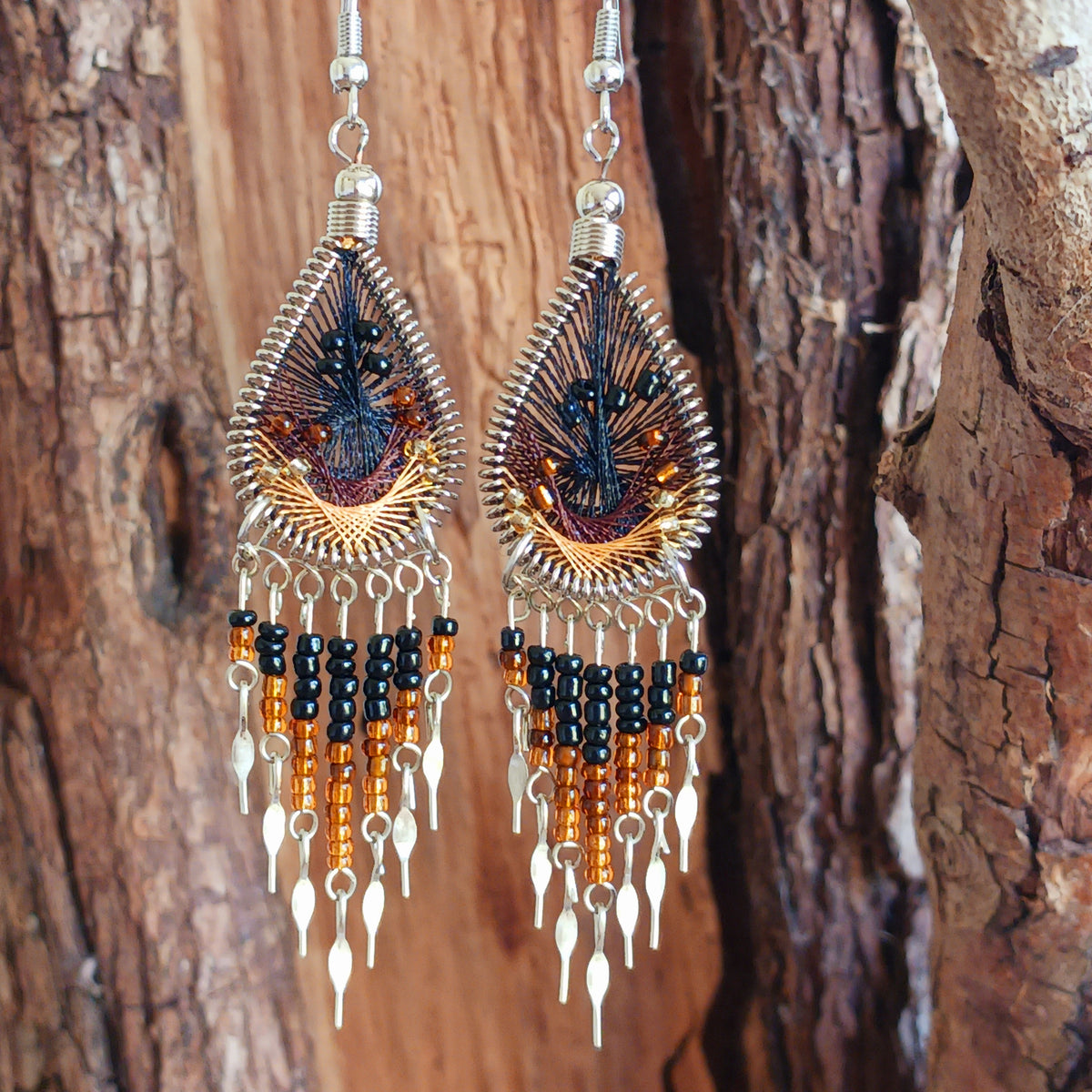 Add a splash of colour to your look with these beautiful handmade Peruvian woven teardrop earrings. Inspired by the vibrant colours and patterns of a peacock feather, each earring features intricate woven detailing complemented by coordinating beads and delicate silver-tone embellishments.