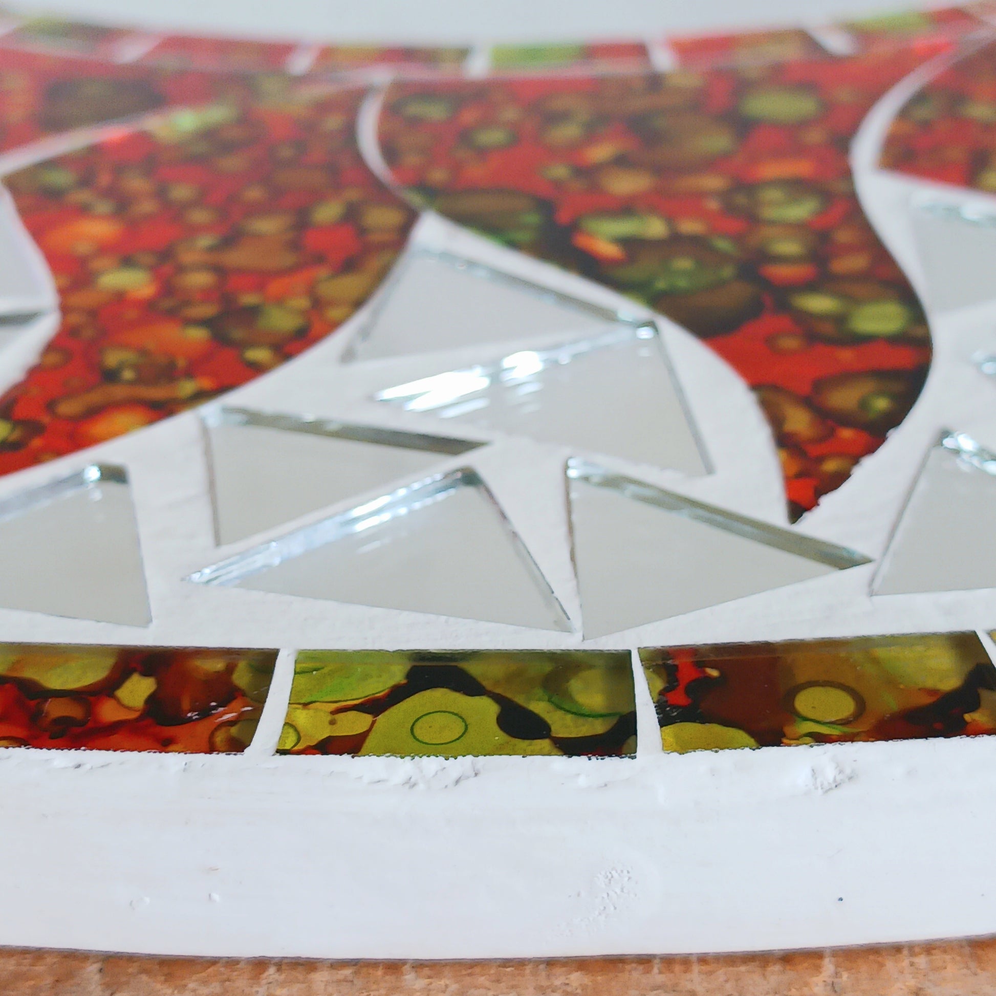 dd warmth, energy, and artistic charm to your home with this beautiful Vibrant Orange Mosaic Sun Mirror. Designed with dazzling orange mosaic tiles arranged in a radiant sunburst pattern, this captivating wall accent instantly brightens any room. 