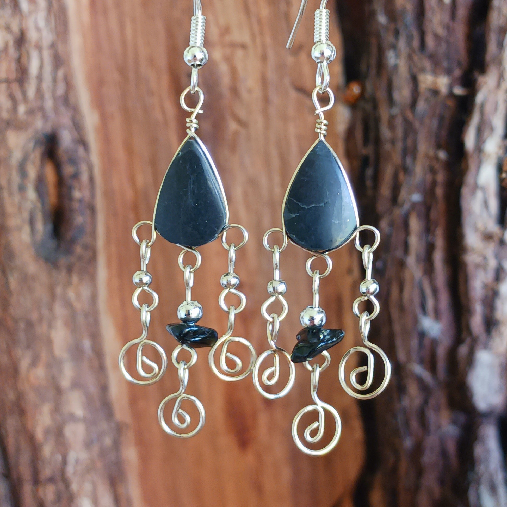 These beautiful spiral earrings feature a turquoise stone and three spirals. They dangle really nicely when worn, and are easy to dress up or down. The hooks are made from sterling silver.