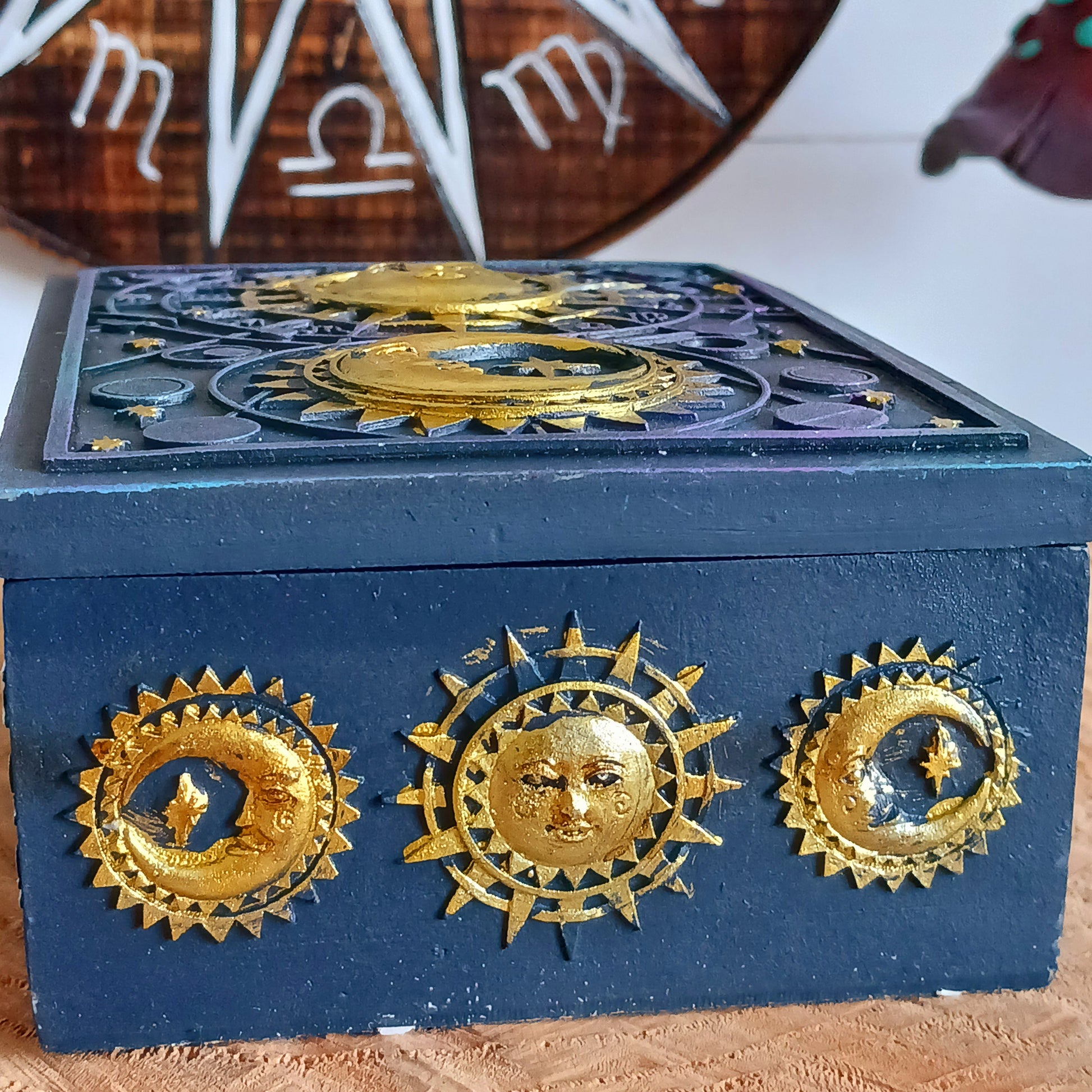 This unusual decorated resin box has raised astrology symbols and a detailed sun and moon design with a gold finish. 
 This celestial style is perfect for holding trinkets, crystals and other small objects for safe keeping.