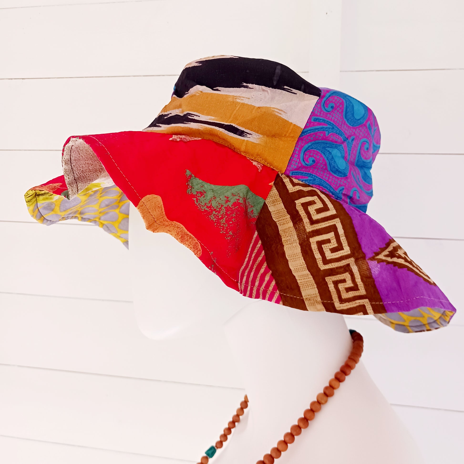 This colourful sunhat is made from patches of remnants from saris. Each hat is unique and features a wide brim to keep the sun from your face and keep you cool, lined with plain cotton to keep you even cooler. These hats are lightweight so easy to carry around in your bag. Ideal for travelling and festivals.