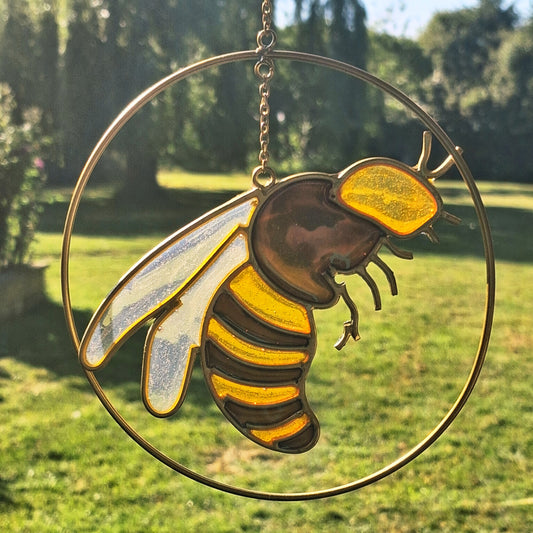 Add a touch of sunshine to the home with this summer bee suncatcher. This charming suncatcher features a beautifully detailed bee, star and crescent moon design made from metal and resin. Hang it in the window to catch the light and bring a cheerful, colourful glow to any room.