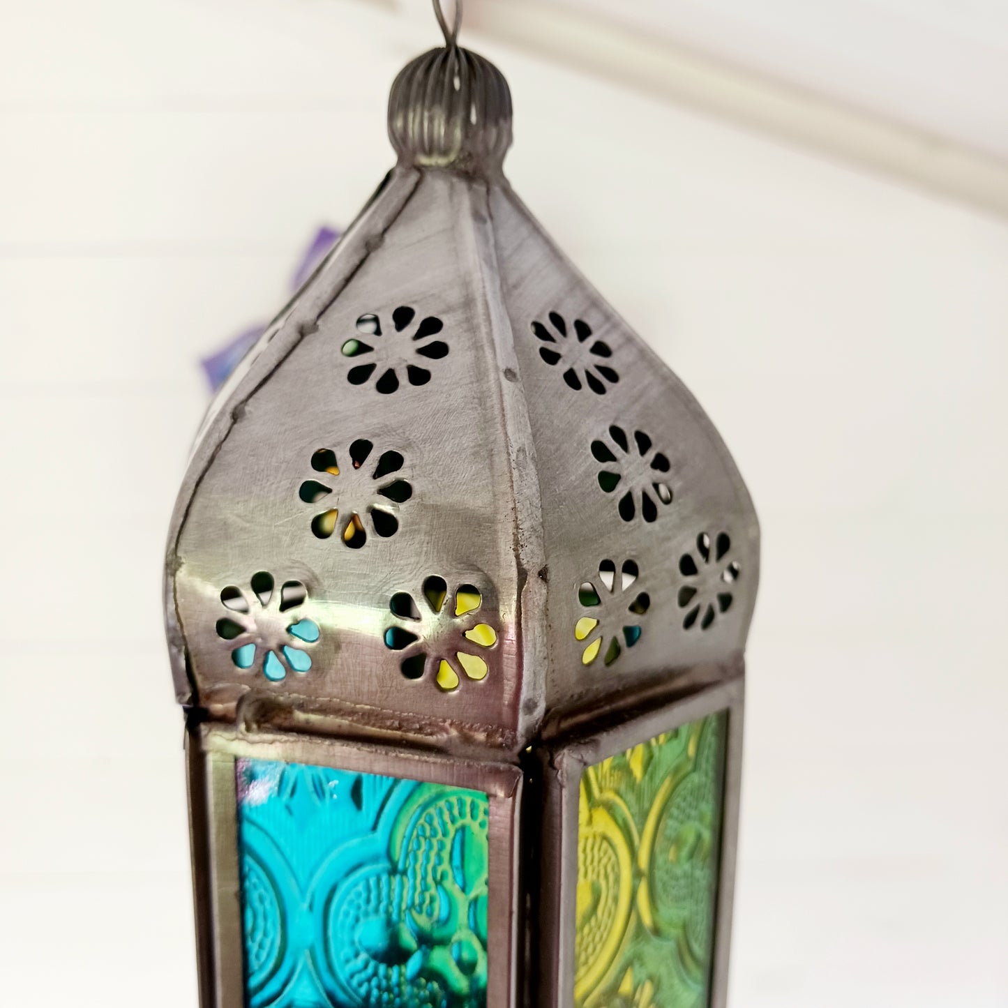 These small glass lanterns come in wonderful colours, featuring an intricate embossed pattern. They have a small hinged door that closes with a sliding catch. The small handle on the top is great for hanging the lanterns around your home. Perfect for adding a touch of warmth to your space.