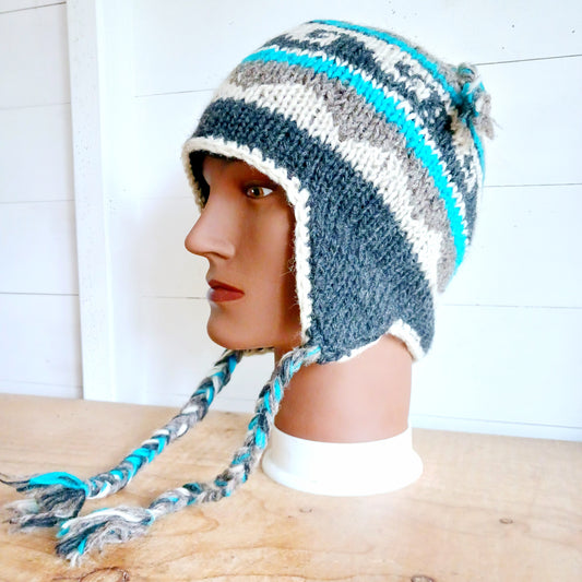 Stay cozy and stylish with our handmade chunky wool earflap hats, crafted in Nepal by skilled women artisans in Kathmandu. Each hat is 100% pure wool and features a soft polar fleece lining for extra warmth and comfort. Perfect for cold winter days, outdoor adventures, or adding a touch of handmade charm to your look.