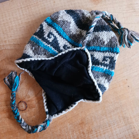 Stay cozy and stylish with our handmade chunky wool earflap hats, crafted in Nepal by skilled women artisans in Kathmandu. Each hat is 100% pure wool and features a soft polar fleece lining for extra warmth and comfort. Perfect for cold winter days, outdoor adventures, or adding a touch of handmade charm to your look.