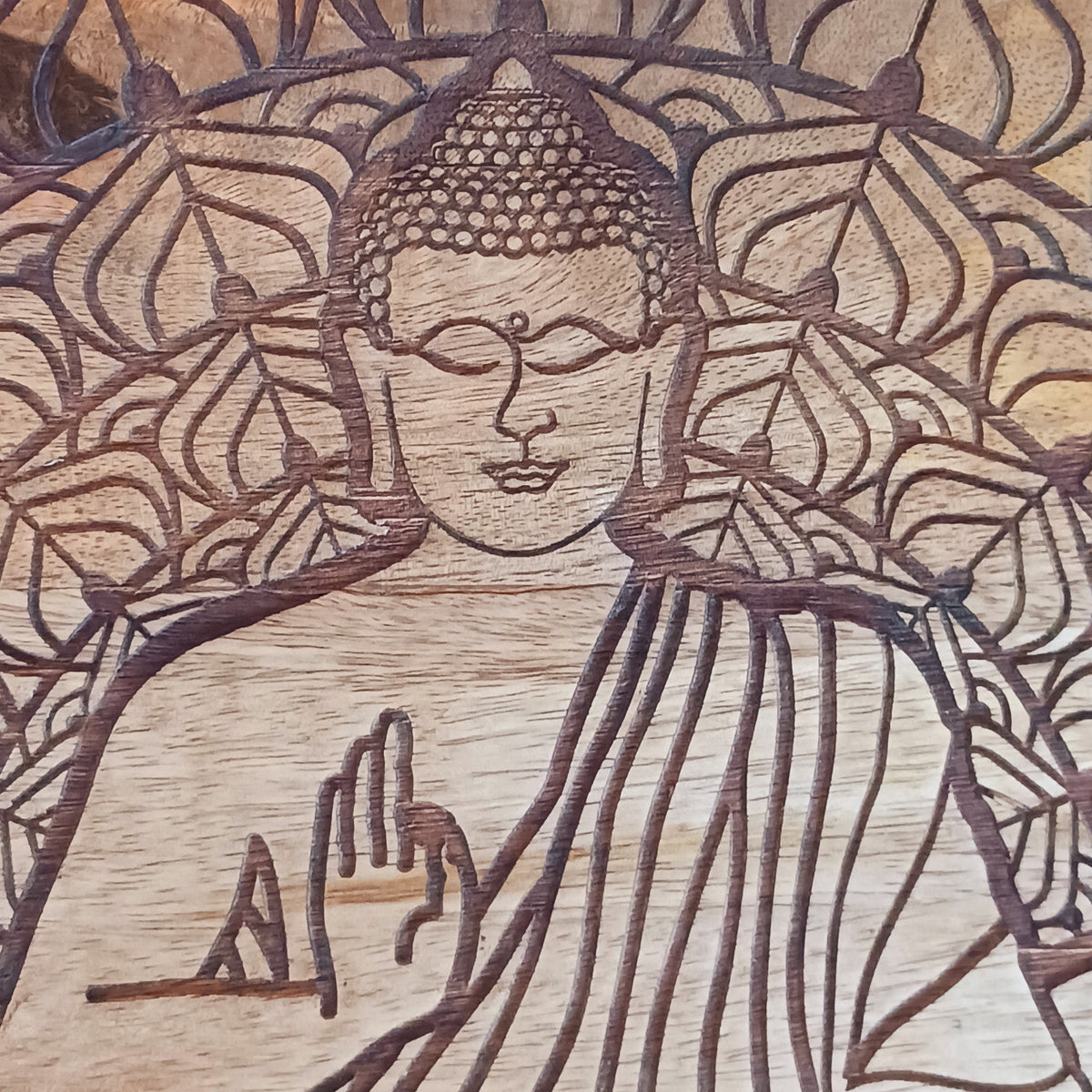 Bring peace and tranquillity to your home with this beautiful handcrafted mango wood table, featuring an intricately carved Buddha and Lotus Flower design on the tabletop. Combining traditional craftsmanship with spiritual symbolism, this unique wooden table makes a wonderful addition to a meditation space, Buddhist altar, yoga room or peaceful home sanctuary.