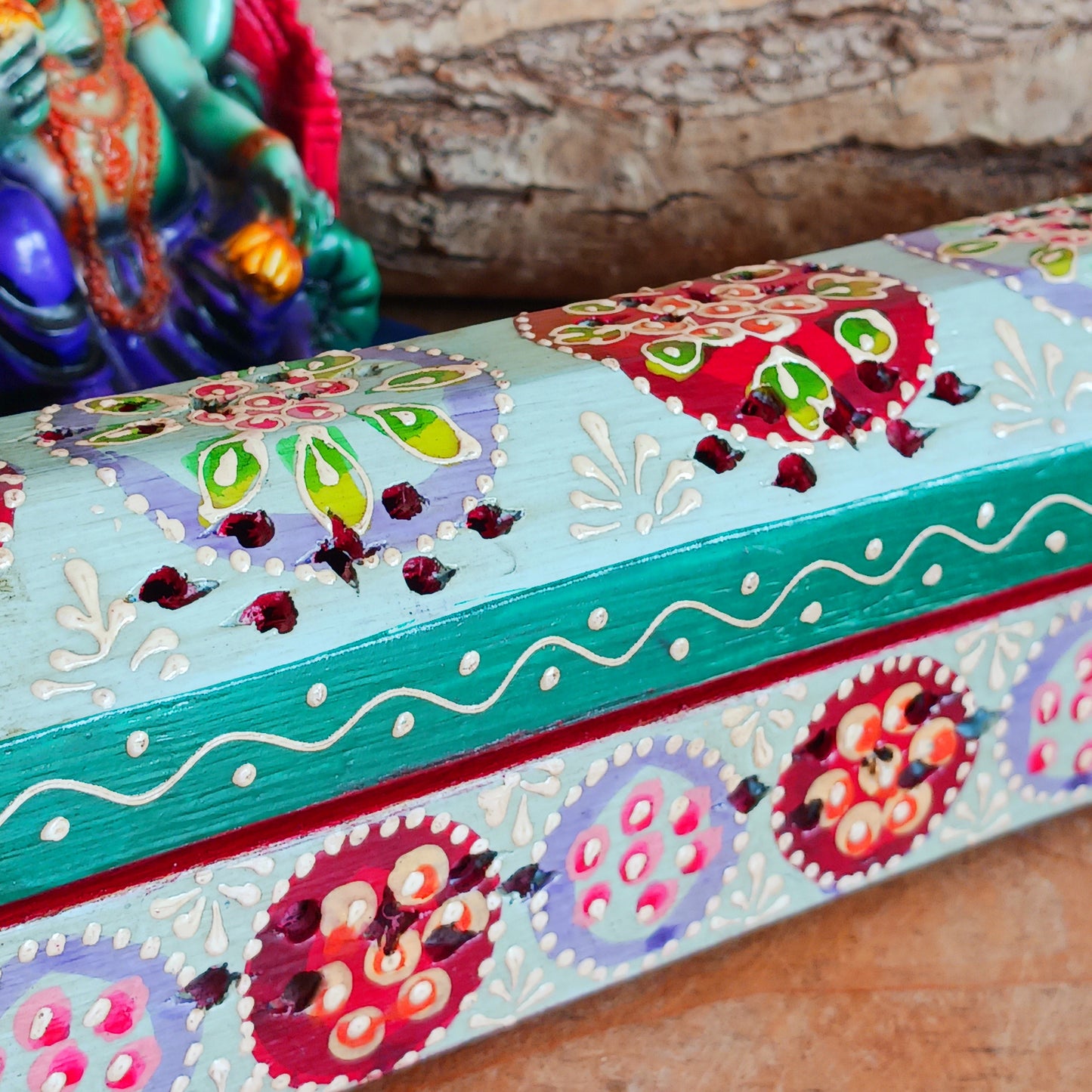 This beautiful turquoise wooden Incense box has been hand painted and has a curved hinged lid. It can accommodate both incense sticks and cones. There is also a place for you to safely store your incense sticks at the bottom on the box.