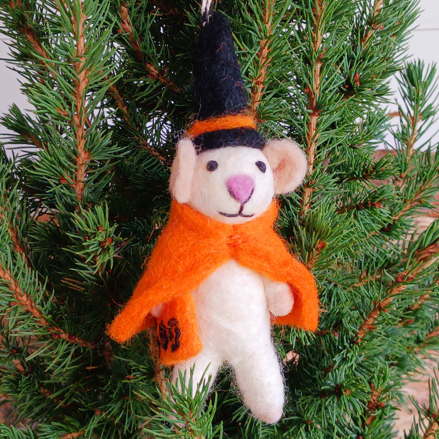 Bring a touch of handcrafted Halloween charm to your home with these delightful felted mice dressed as a playful “Boo” character. Each mouse features adorable details including long tails, soft pink ears and noses, and colourful pointed hats and capes. These little mice have a “Boo” sign—and comes with a black-and-white hanging thread, perfect for decorating branches, hooks, garlands, or spooky seasonal displays.