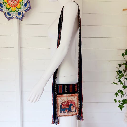 This handy little shoulder bag has a wide strap that is long enough to use as a shoulder or crossbody bag and also makes it comfortable to wear for long periods. The main fabric is traditional with a beautiful embroidered elephant design on the front. The bag is finished with tassels.