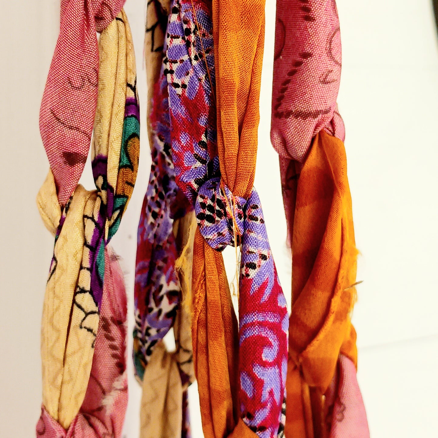Add a burst of colour and a touch of boho charm to your home with these beautiful Large Recycled Sari Plant Hangers. Each hanger is handcrafted from upcycled sari fabric, giving new life to discarded textiles while ensuring no material goes to waste. Their simple yet elegant design allows them to complement any décor style, from minimal to eclectic. Featuring a sturdy metal ring for easy hanging, they are perfect for showcasing your favourite indoor plants in a sustainable and stylish way.