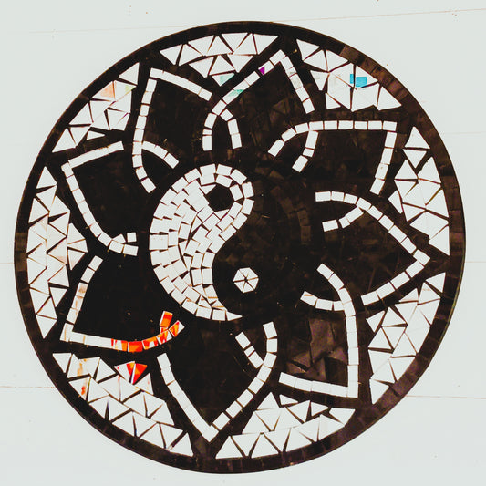 Bring balance, energy, and harmony to your space with this large handcrafted Mosaic Yin and Yang Wall Plaque. Each plaque is carefully created using small glass pieces, meticulously arranged to form a striking black and silver yin and yang design. The reflective mosaic catches the light beautifully, adding depth and elegance to any room. 